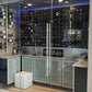 Black acrylic wine bottle display wall with multiple rows of bottles