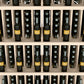 Grey-toned wine bottle wall display with five shelves and bottle storage slots