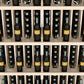 Light wood wine bottle wall display with 5 shelves; bottles shown in front slots