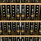Close-up of wine bottle wall display shelves with rows of bottles and dividers