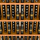 Close-up of wine bottle display shelves with bottles seated in front slots