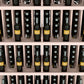 Wine bottle display shelf close-up with pale wood dividers and bottle rows