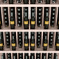 Close-up of wall wine bottle display showing bottles in five shelf rows