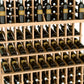 Close-up of wine bottle display shelves with light wood frame holding bottles