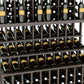 Triple-tier wine bottle display with dark gray lattice shelves holding green bottles