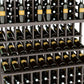 Close-up of upright wine bottles on slatted wooden shelves in a grid rack