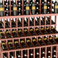 Wine bottle display rack close-up with red-brown shelves holding dark glass bottles