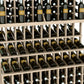 Triple-tier wine bottle display with light wood rails and filled bottle rows