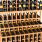 Wood triple-tier wine bottle rack with angled slots and three rows of bottles