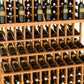 Light wood triple-tier wine bottle display rack with double-deep base, holding dark bottles