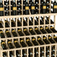 Triple-tier wine bottle display with light wood slats and rows of dark wine bottles
