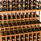 Triple-tier wine bottle display with warm wood slats and multiple rows of wine bottles
