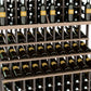 Triple-tier wine bottle display rack with walnut-brown lattice shelves and dark bottles
