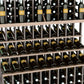 Close-up of triple-tier wine bottle rack with bottles stored in horizontal wooden shelves