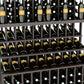 Wine bottle display rack detail with dark slats holding bottles on three tiers