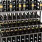 Close-up of wine bottles in a triple-tier wooden display rack with slotted shelves