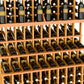 Triple-tier wine bottle display rack with natural wood slats and rows of bottle openings